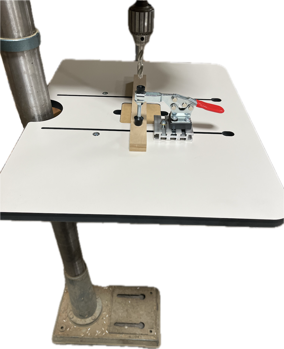 The image shows a Woodhaven 1828 Toggle Clamp attached to a drill press table, designed to hold workpieces in place for drilling.