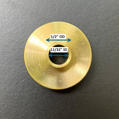 Gold metal bushing with measurements on a gray background