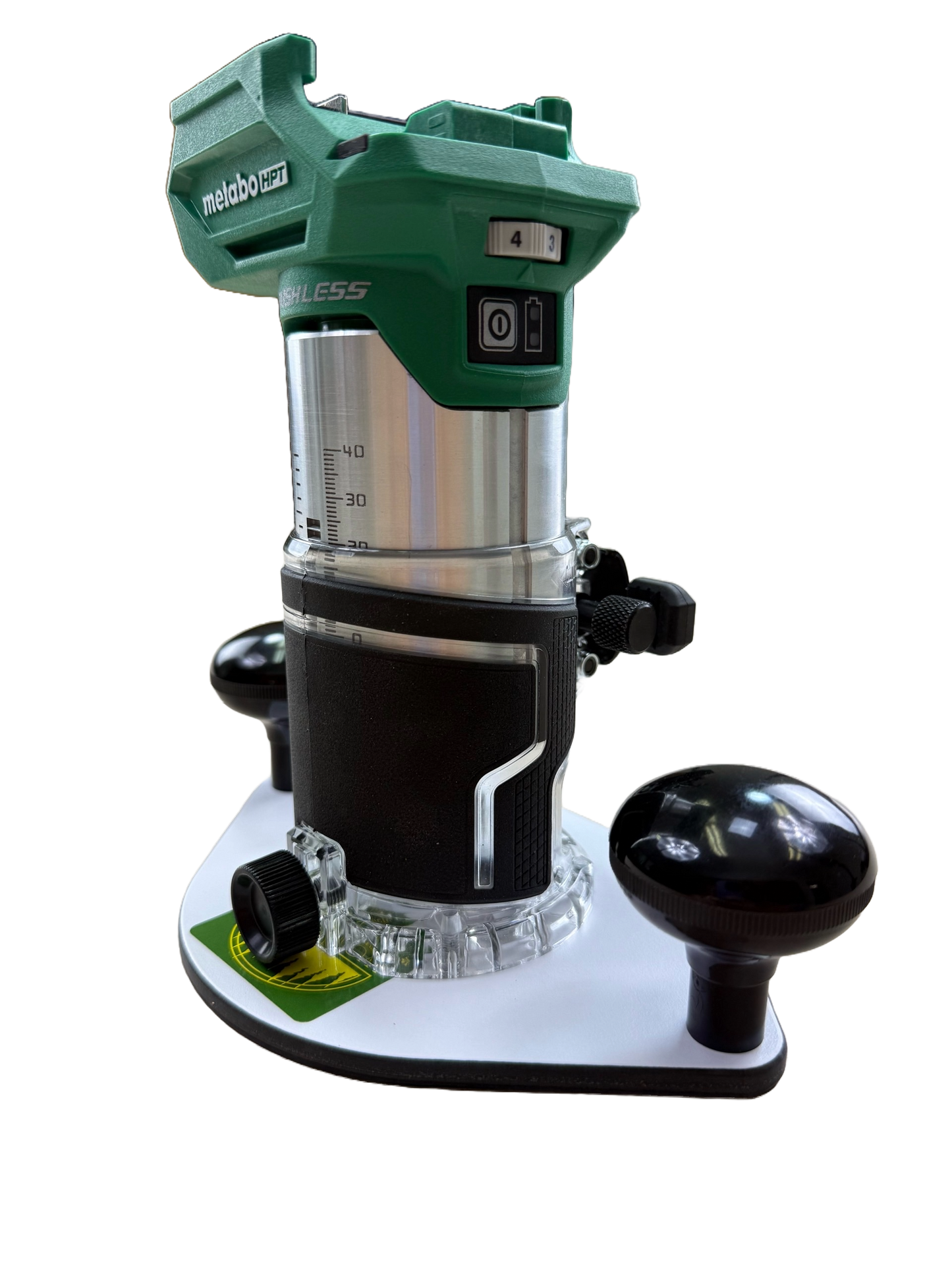 Green and black router with Metabo branding on a white plate