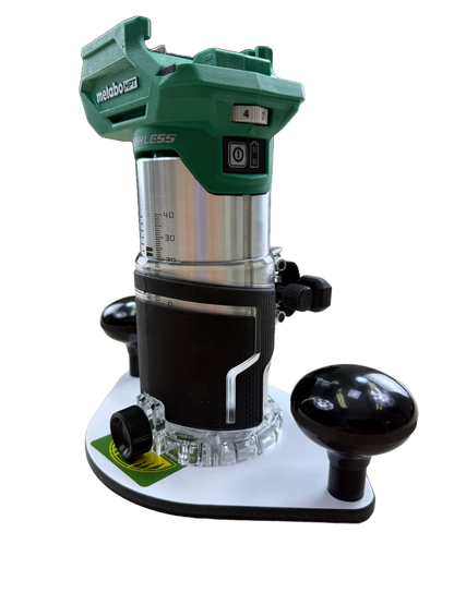 Green and black router with Metabo branding on a white plate