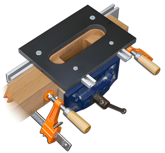 A router jig designed for creating mortises for invisible hinges, with a black top surface, blue sides, and orange clamps attached to a wooden workpiece.
