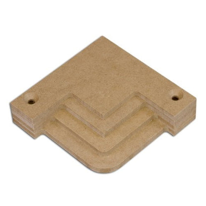 A stack of beige wooden corner templates of varying sizes designed for creating decorative corners in frame and panel woodworking projects.