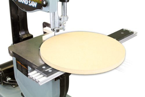 A band saw circle cutting jig in use, where a circular piece has been cut from the wood that is mounted on the saw's blade.