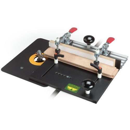 A medium-sized black coping sled with adjustable feed handles and inboard toggle clamps, designed for making precise cuts on a router table or shaper.