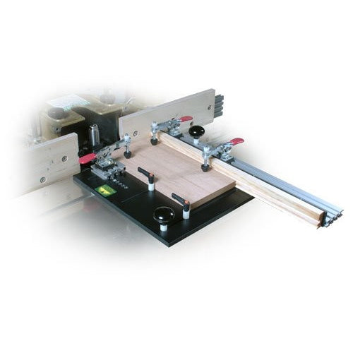 A Woodhaven large coping sled, primarily black in color, with clamps and adjustable feed handles, designed for making precise cuts on a router table or shaper.