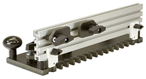 A router table dovetail jig with a metal template and black plastic or rubber components, designed for cutting half-blind dovetail joints in wood.