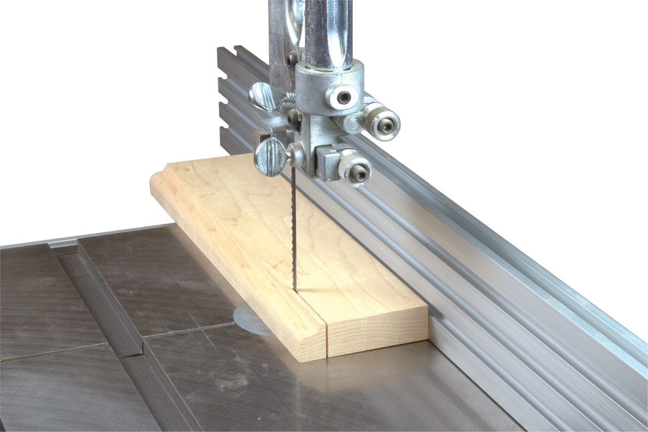 A band aw cutting  a board with an upgraded fence